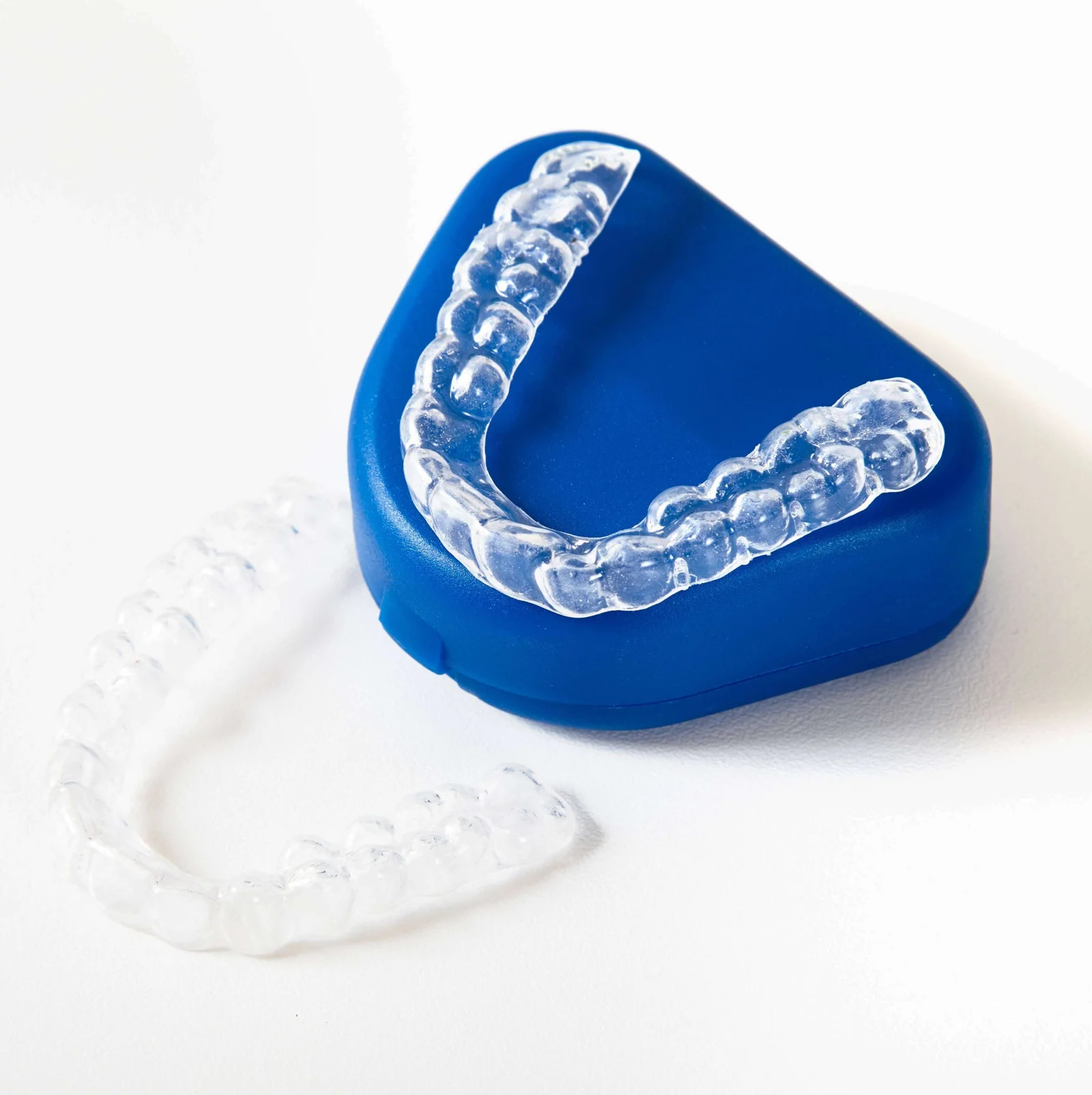 Alinhadores invisíveis transparentes sobre estojo azul, solução moderna de ortodontia estética na clínica Oral Mac em Jundiaí.